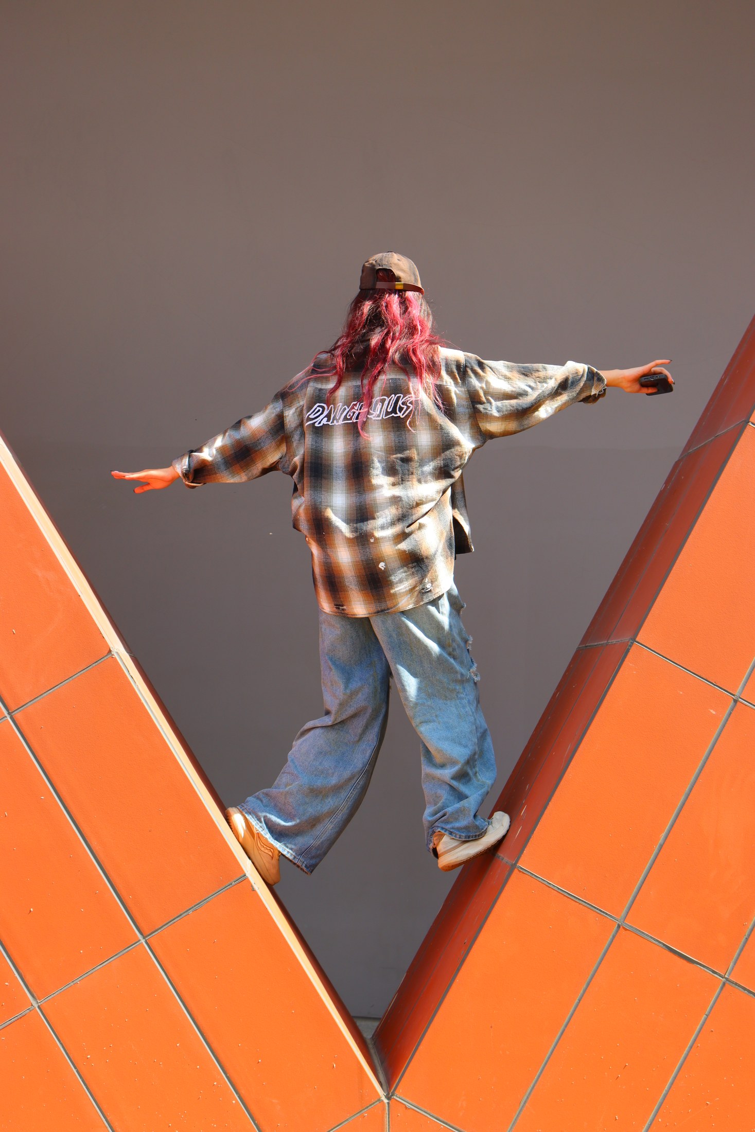 Figure framed by orange architecture