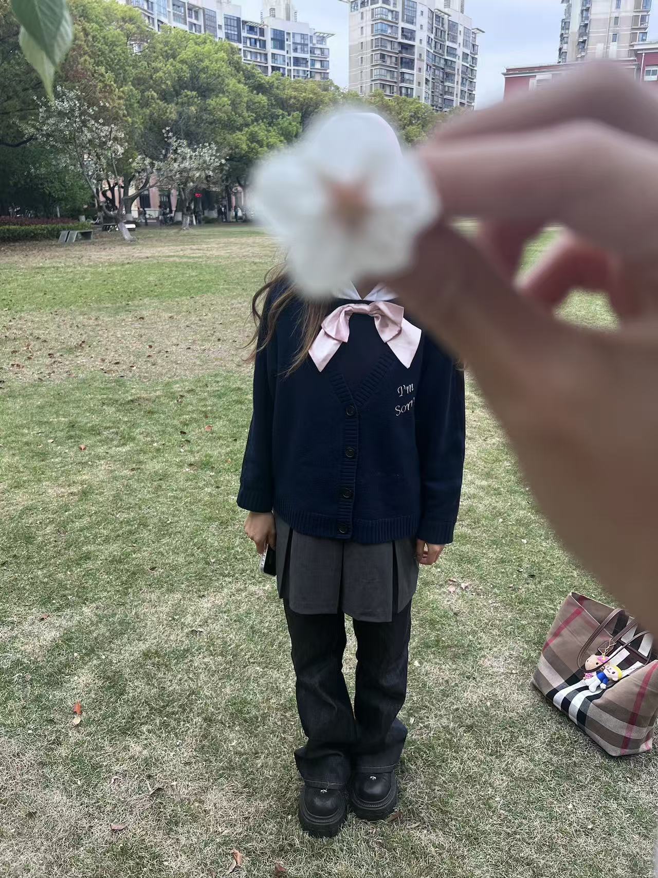 Flower held in front of a portrait